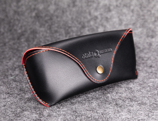 The Sunglasses Case Is Black with A LOGO Printed on It And Looks Like A Leather Bag