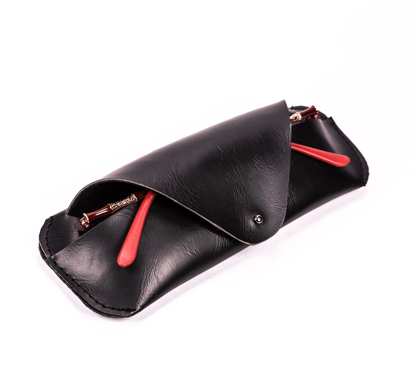 The Black Clamshell Is A Triangular Eyeglass Case Shaped Like A Wallet