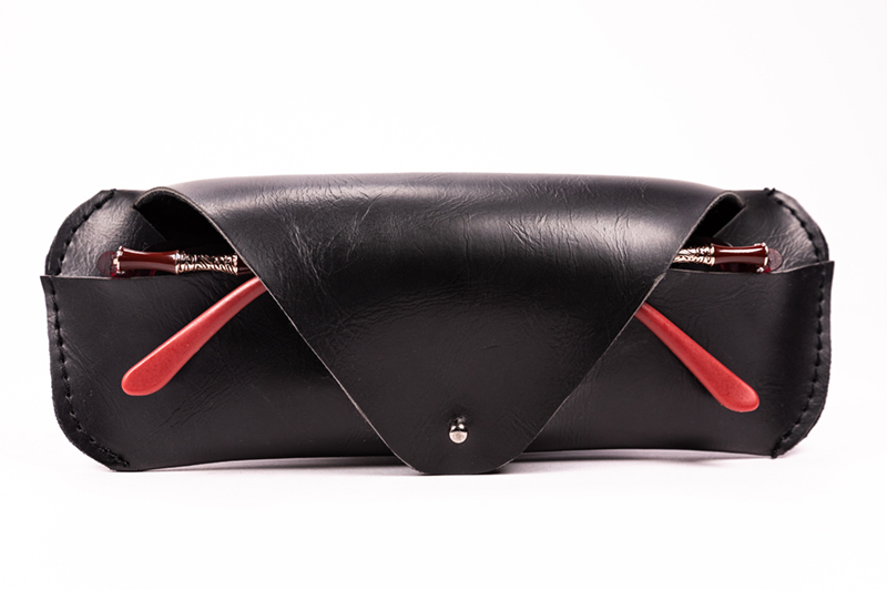 The Black Clamshell Is A Triangular Eyeglass Case Shaped Like A Wallet